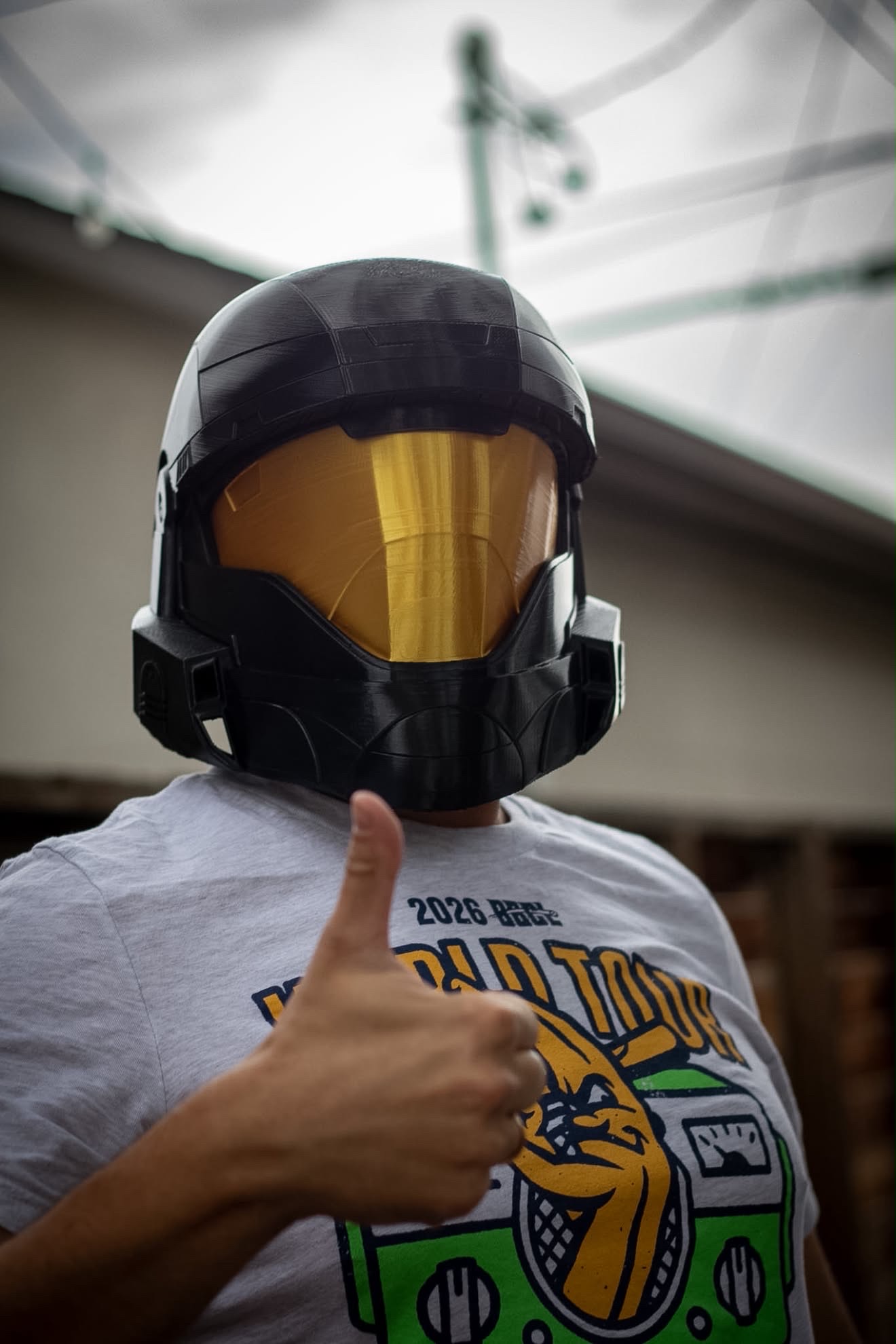 Player wearing a 3D-printed Halo helmet giving a thumbs up at a Level Up LAN party
